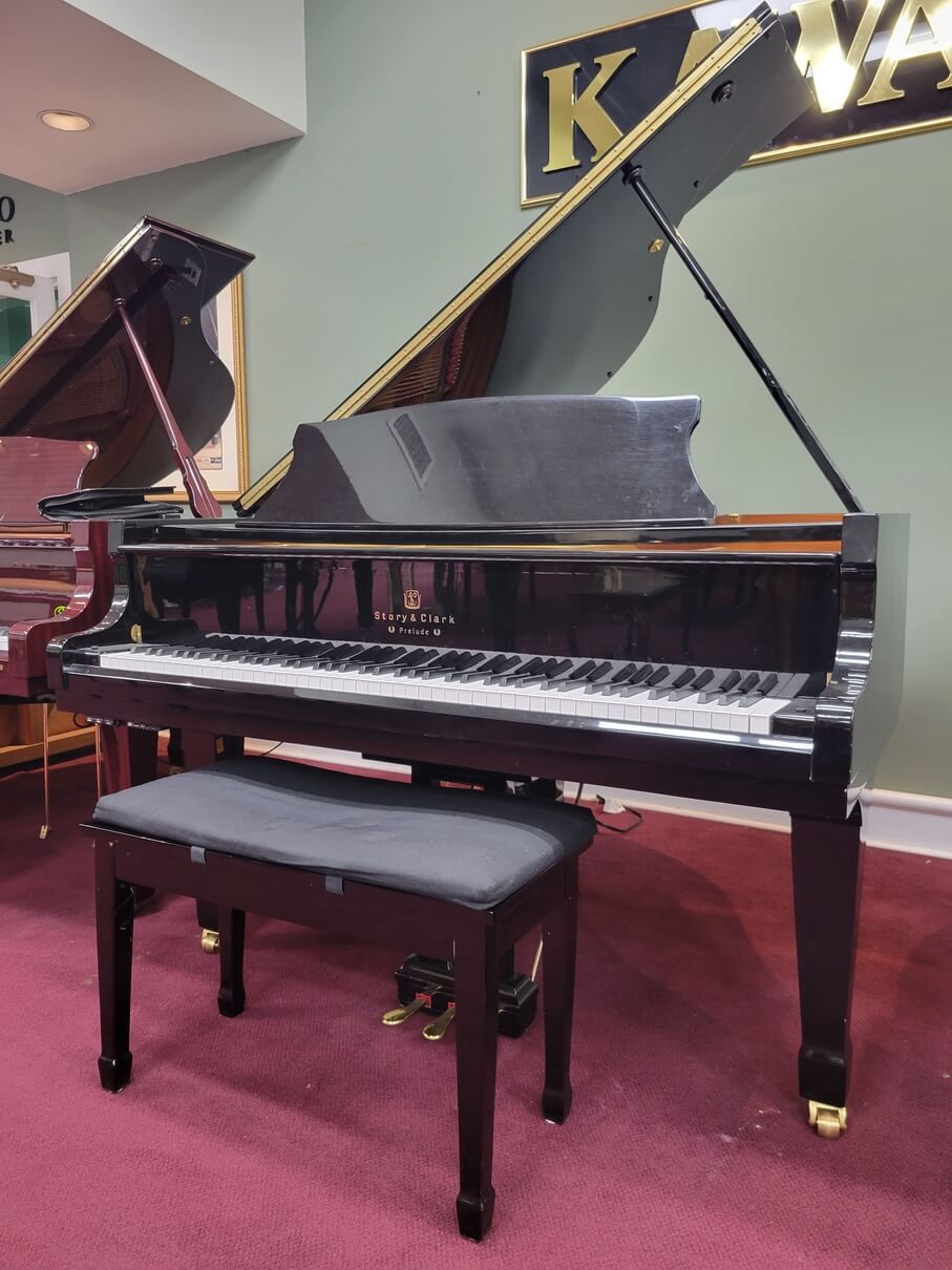 This is a detailed image displaying a 1999 Story & Clarke Prelude Grand Piano.
